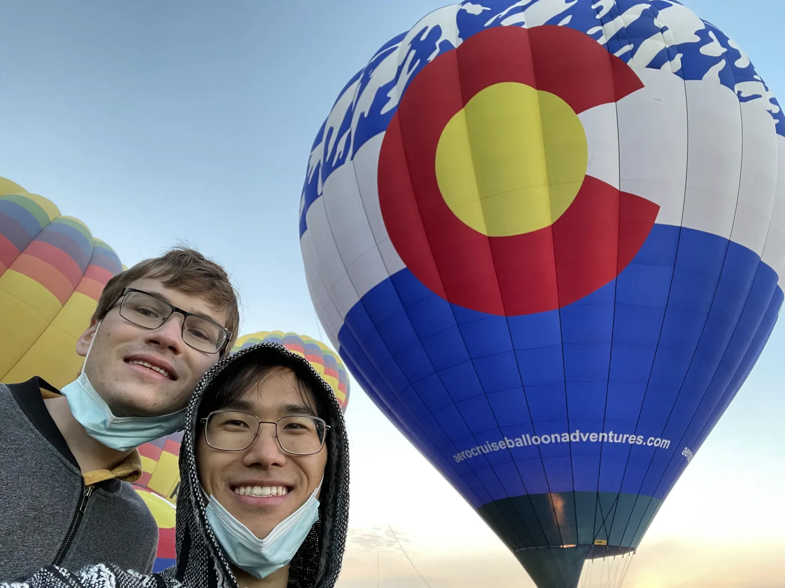 Jack and Bo in front of a Colorado flag hot air balloon