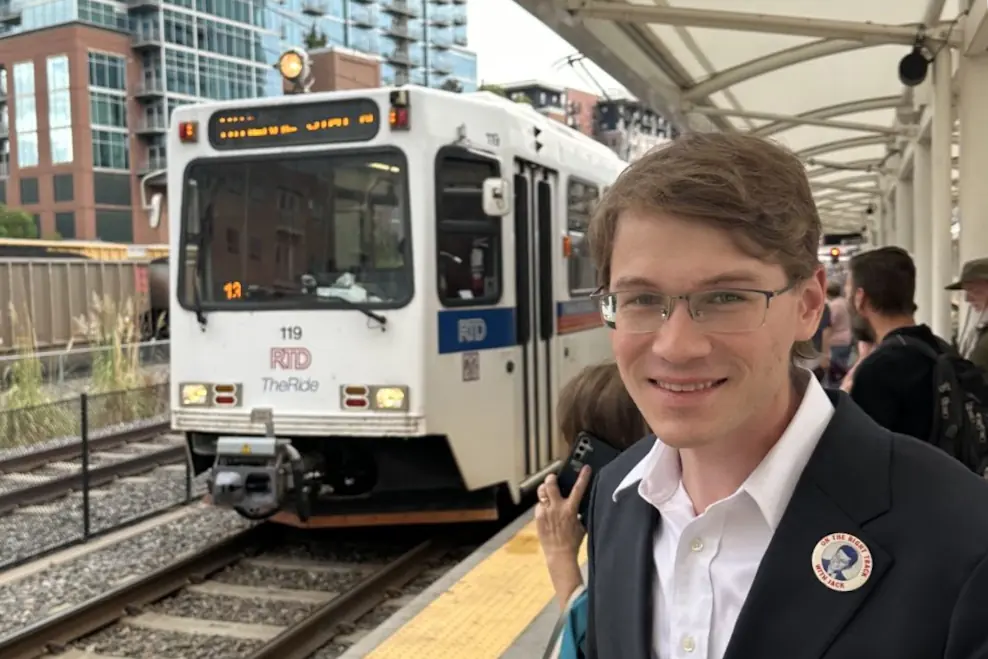 Jack waiting on an RTD light rail platform as a train arrives